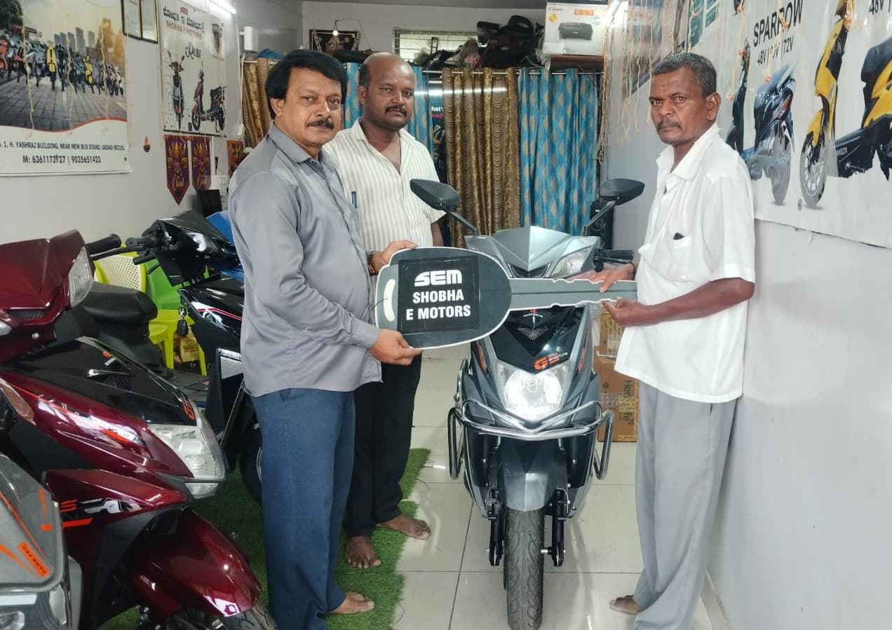 Scooter delivery ceremony with ceremonial key at Shobha E Motors